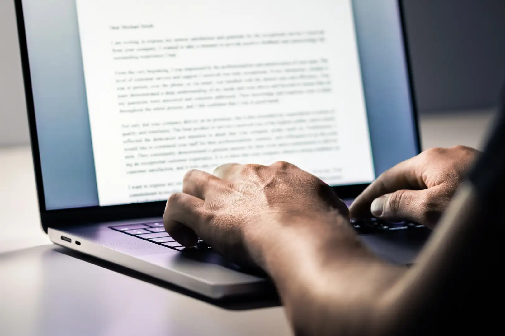 content-writing-service-1 Hands typing on a laptop, screen shows text for content writing.